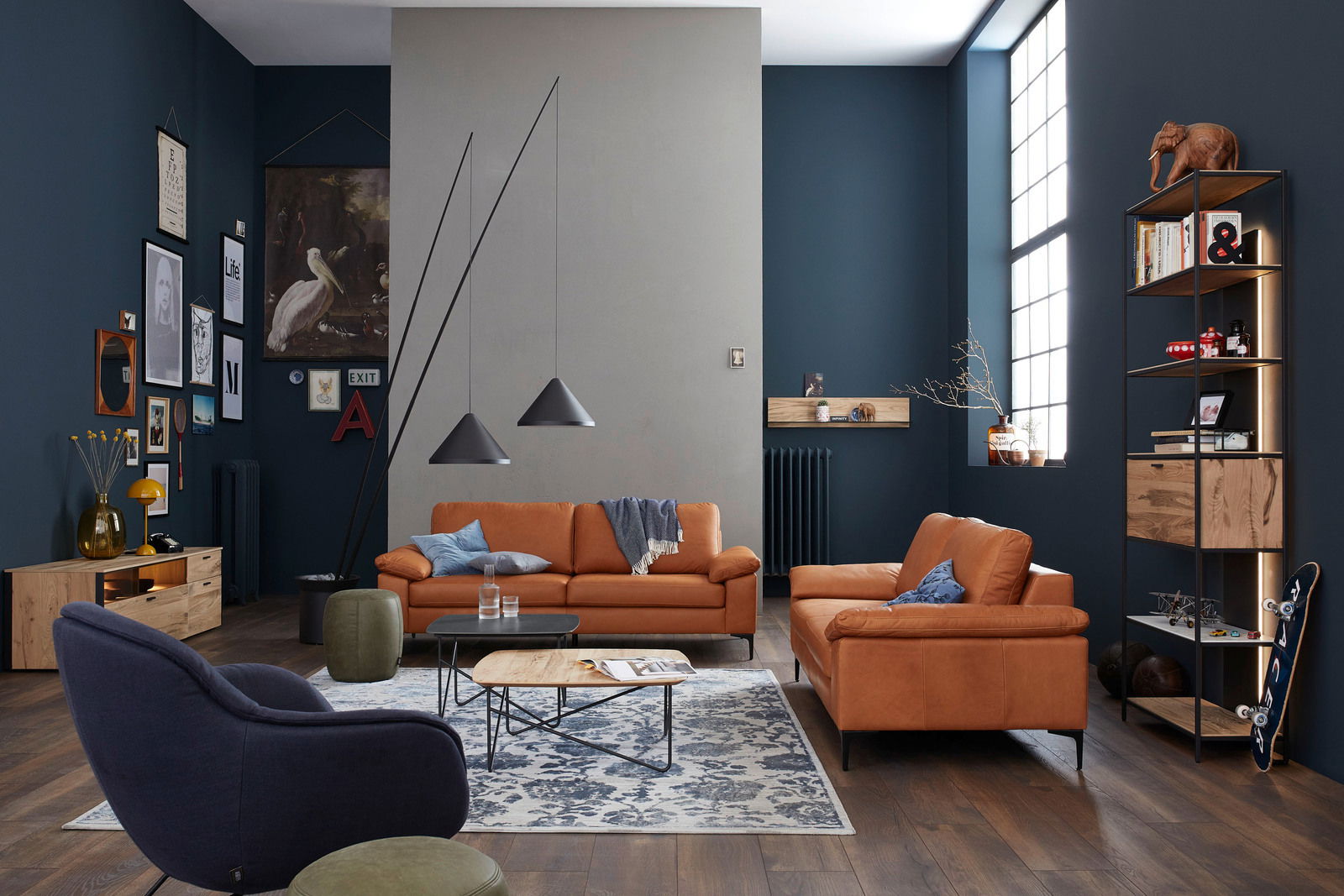 Wohnzimmer mit zwei orangefarbenen Sofas, modernem Design, von vorne betrachtet. Dekoriert mit blauen Kissen und einer Decke, umgeben von stilvollen Möbeln und Kunstwerken an der Wand.
