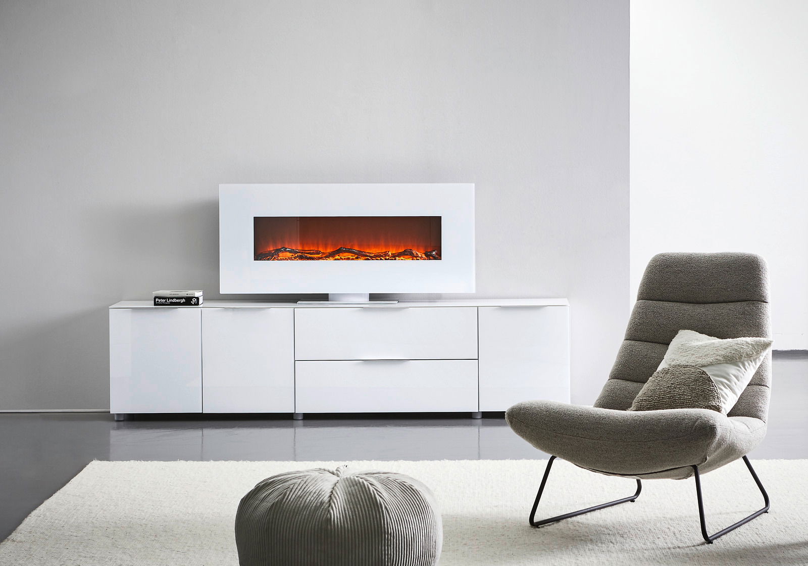 Modernes weißes XL-TV-Lowboard mit integriertem elektrischen Kamin, frontal abgebildet in einem stilvollen Wohnzimmer.