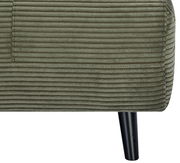 Nahaufnahme eines grünen Funktionssessels mit geripptem Stoffbezug und schwarzem Bein, seitliche Perspektive.