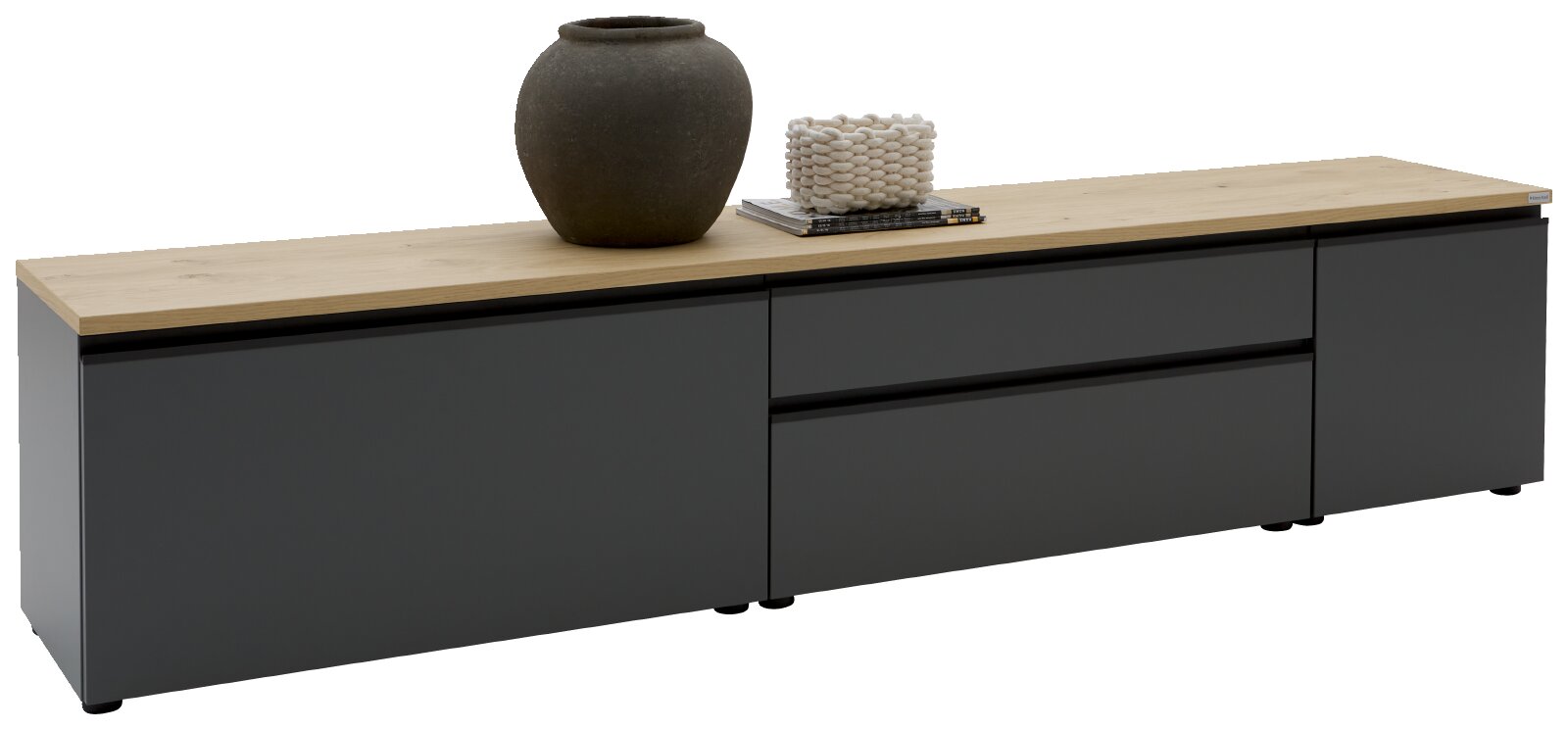 Modernes TV-Lowboard in Anthrazit mit heller Holzplatte, zwei Schubladen und zwei Türen, dekoriert mit Vase und Büchern, in schräger Frontansicht