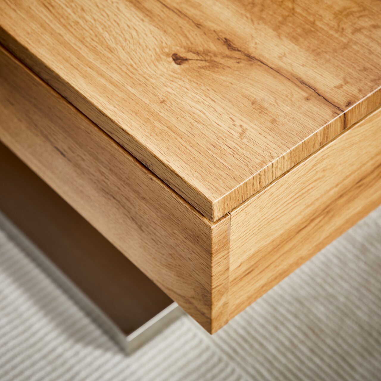 Nahaufnahme eines Couchtischs aus Holz mit natürlicher Maserung, perspektivisch von oben fotografiert.