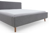 Graues Polsterbettgestell MATTIS mit Holzfüßen, seitliche Perspektive
