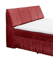 Rood boxspringbed met gestoffeerd hoofdeinde, zijaanzicht