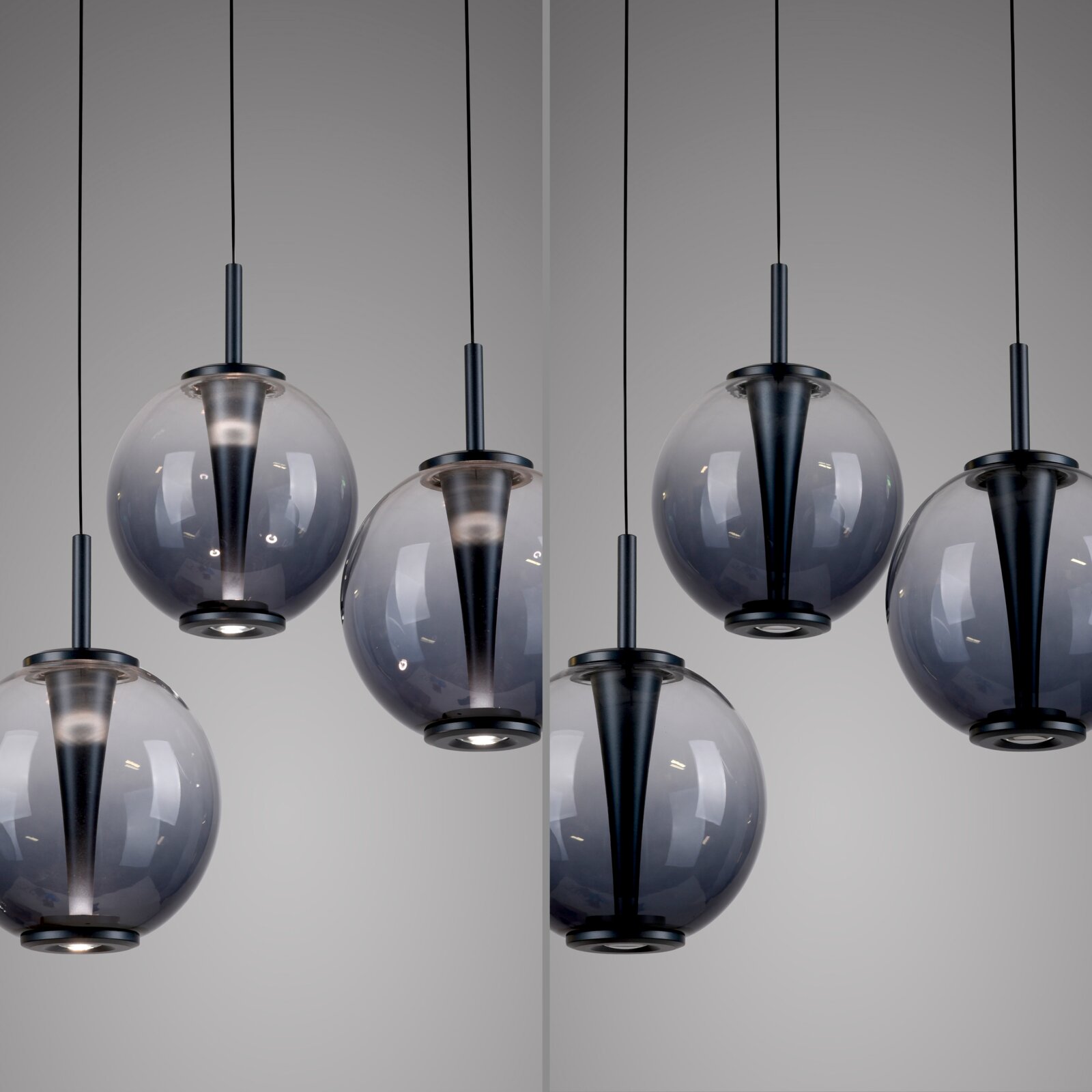 Moderne LED-Pendelleuchte mit kugelförmigen, rauchgrauen Glasschirmen, aus seitlicher Perspektive fotografiert.