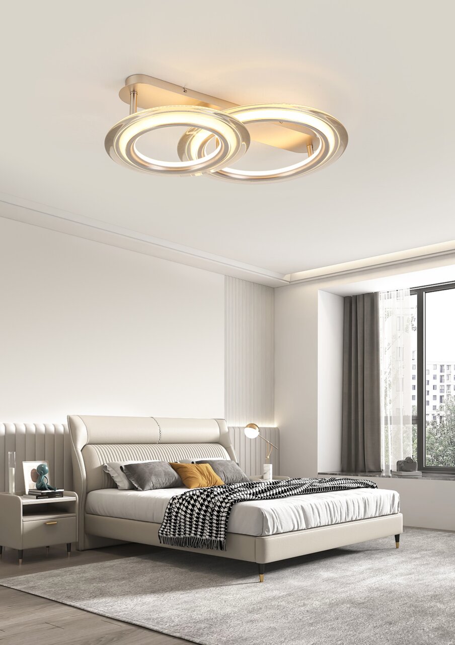 Moderne LED-Deckenleuchte mit zwei ineinander verschlungenen Ringen, von unten betrachtet, in einem stilvollen Schlafzimmer montiert.
