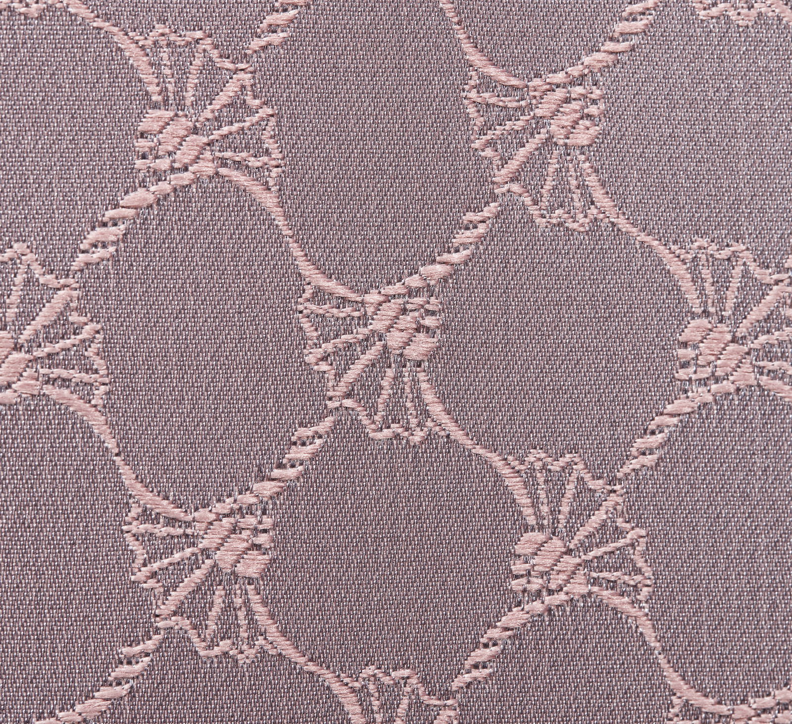 Nahaufnahme eines Stoffes mit einem eleganten, kreisförmigen Muster in Nude-Tönen.