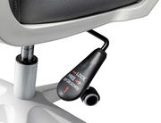 Nahaufnahme eines Drehstuhls mit Fokus auf die Höhenverstellung und Arretierung, seitliche Perspektive.