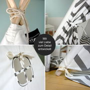 Detailansicht eines grauen Tipi-Zelts mit Zickzack-Muster, das mit viel Liebe zum Detail entwickelt wurde. Perspektive zeigt Nahaufnahmen von Knoten, Fenster und Stoffmuster.