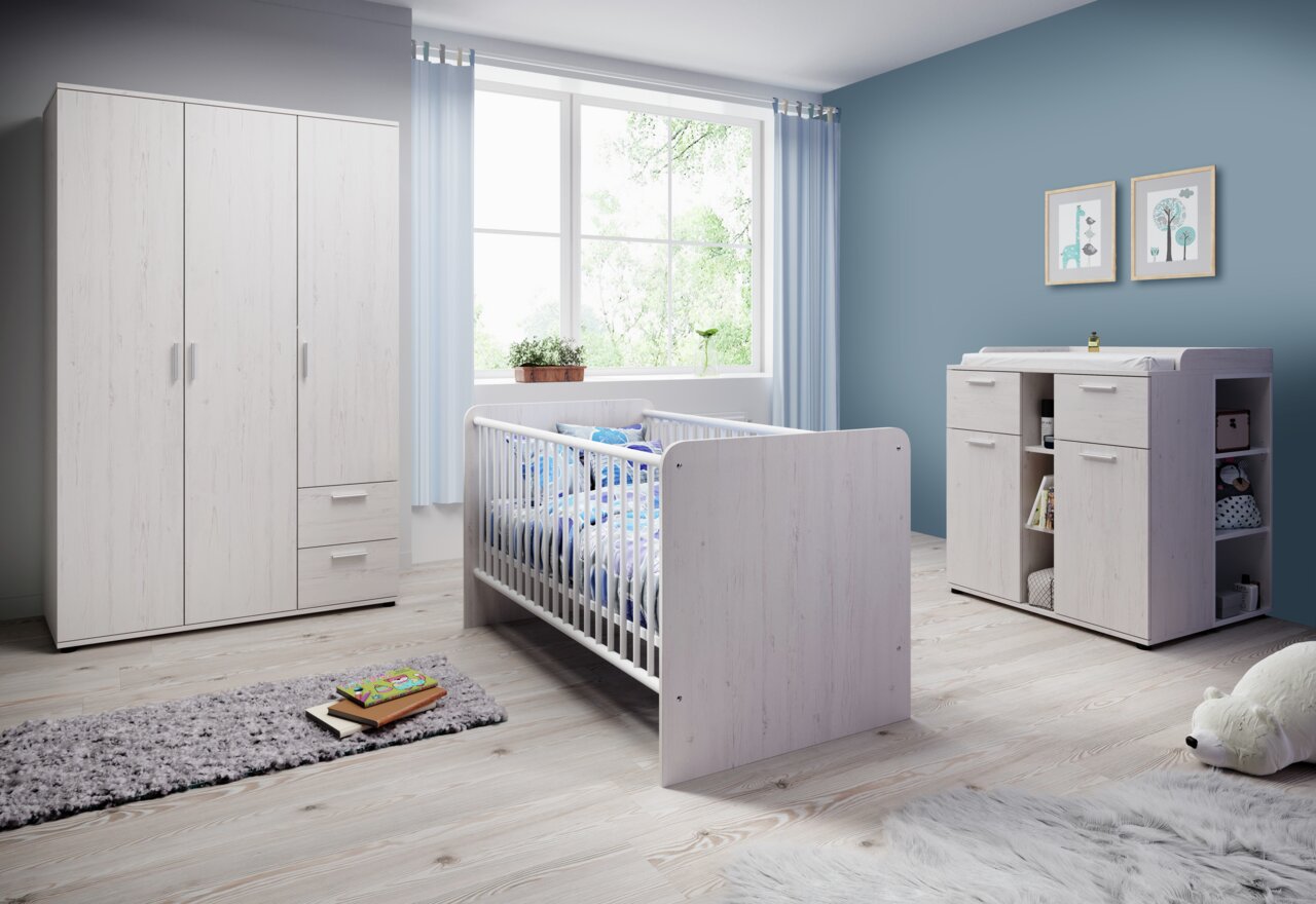 Kinderzimmer mit weißem Holzschrank, Gitterbett und Wickelkommode, seitliche Perspektive