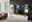 Moderne Wandkombination in einem Wohnzimmer mit TV, Vitrine und Regalen, aus hellem Holz und weißen Elementen, seitliche Perspektive.