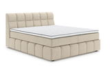 Beiges Boxspringbett mit gestepptem Kopfteil, seitliche Perspektive