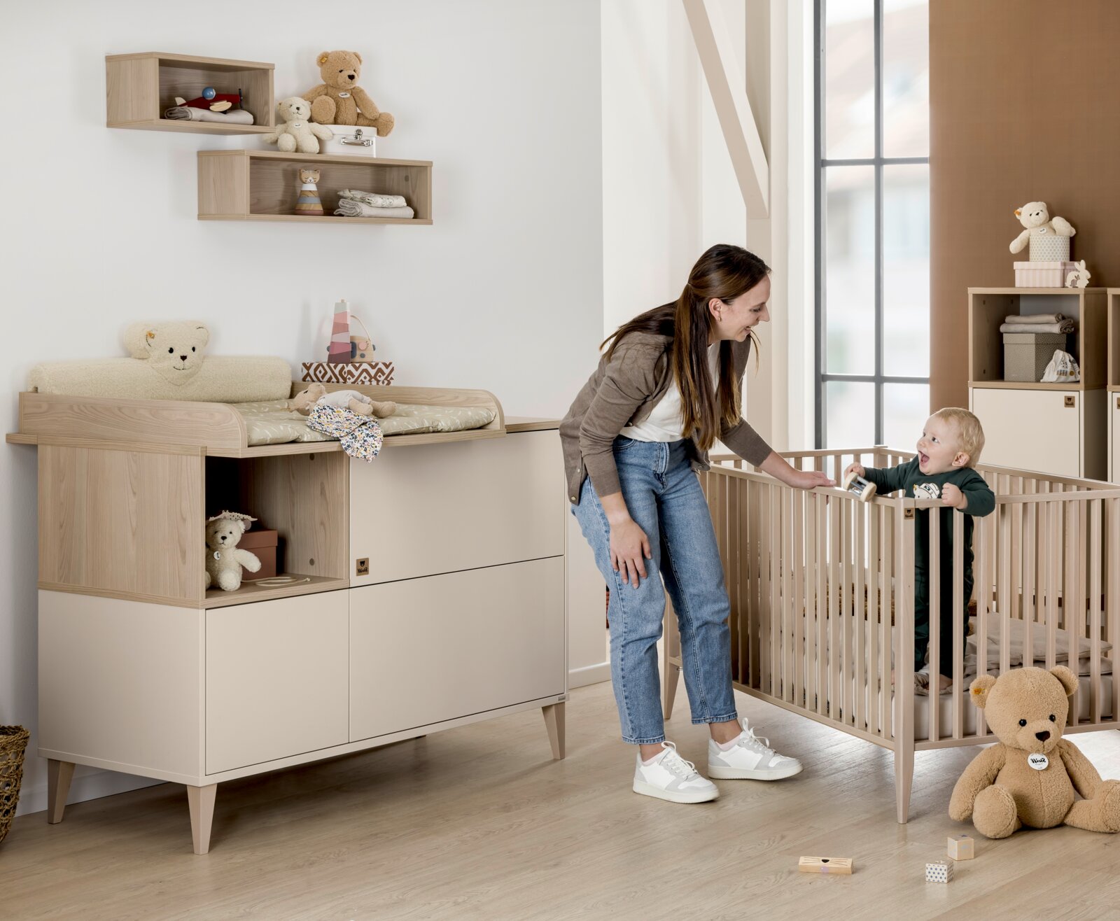 Kinderzimmer mit Wandboxen, Wickelkommode und Gitterbett, seitliche Perspektive