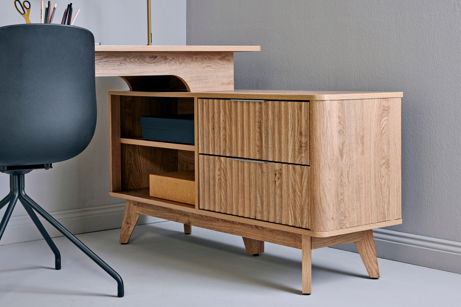 Moderner Eck-Schreibtisch aus Holz mit Schubladen und Regalfächern, seitliche Perspektive