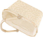 Beige Babywippe mit dezentem Leopardenmuster und gepolstertem Rahmen, Ansicht schräg von oben auf Sitzfläche und Gestell