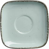 Vogelperspektive auf eine quadratische, blaue Espressountertasse mit rustikalem Rand.