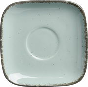 Vogelperspektive auf eine quadratische, blaue Espressountertasse mit rustikalem Rand.