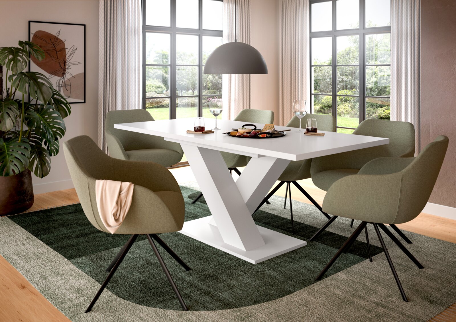 Moderner Esstisch mit weißer Y-förmiger Basis, umgeben von grünen Stühlen in einem hellen Raum mit großen Fenstern, aus seitlicher Perspektive.