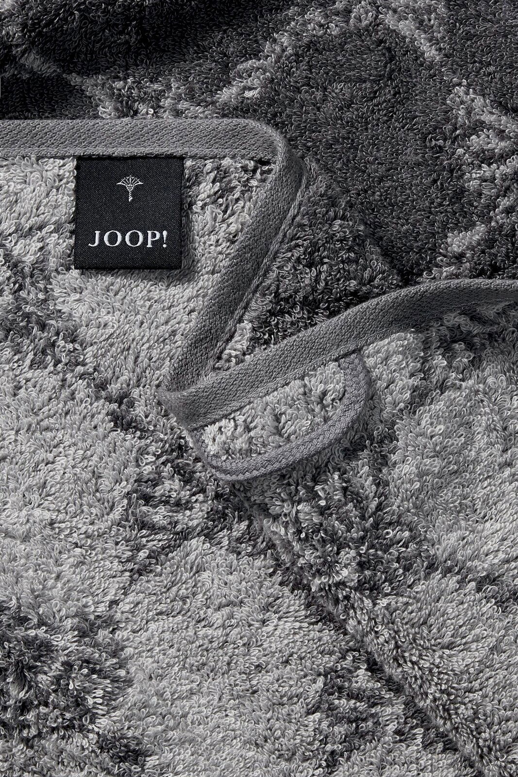 Graues Duschtuch mit geometrischem Muster und Markenetikett, Nahaufnahme