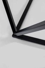 Nahaufnahme eines schwarzen Metallgestells eines Beistelltisches aus der Vogelperspektive.