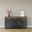Set one by Musterring Sideboard YORK Modernes Sideboard in dunklem Grau mit Holzplatte, dekoriert mit einer Vase und einem gerahmten Bild, aus frontaler Perspektive.