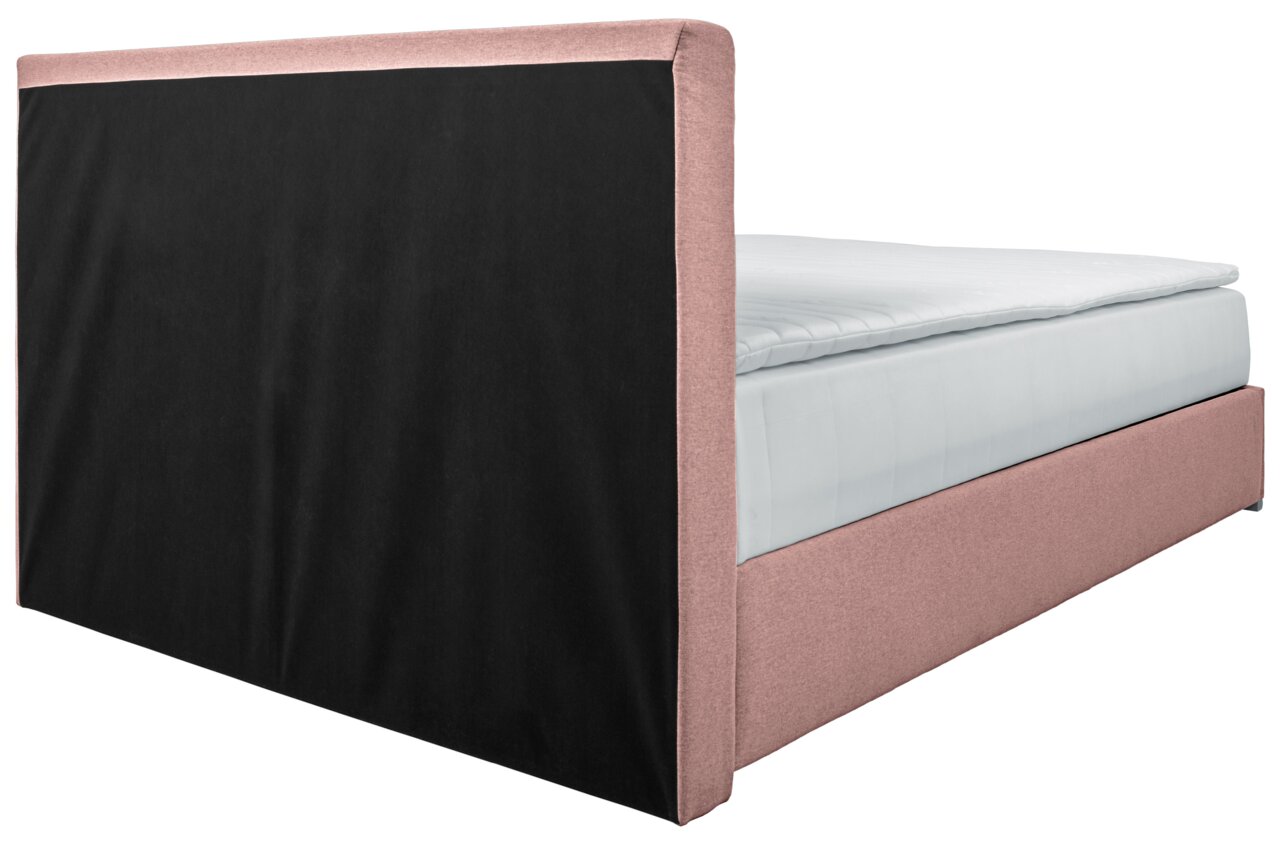 Boxbed 140 in zijaanzicht met roze bekleding en een zwart hoofdeinde.