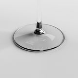 Nahaufnahme des Fußes eines Kelchglases mit der Aufschrift 'Schott Zwiesel', auf einer weißen Oberfläche.