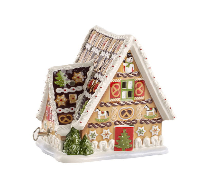 Lebkuchenhaus mit Spieluhr, seitliche Perspektive, verziert mit weihnachtlichen Motiven wie Schneemann, Tannenbaum und Lebkuchenmuster.