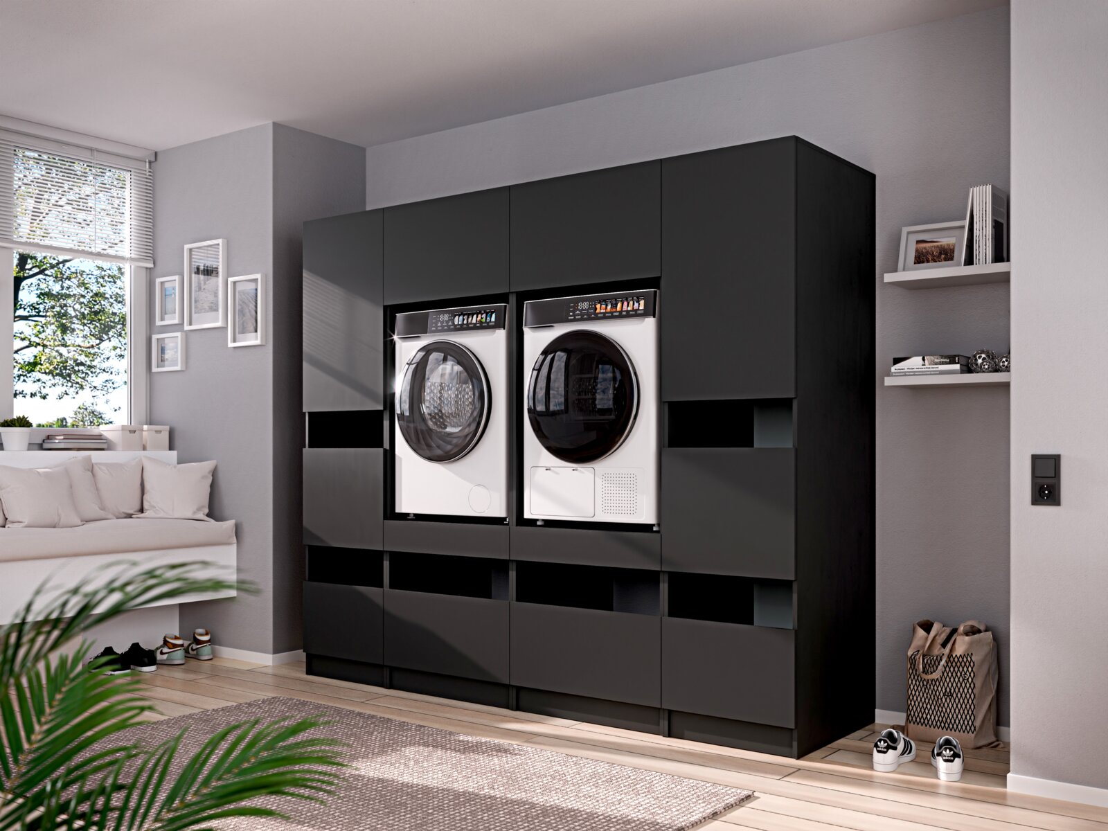 Modernes, matt-schwarzes Einbau-Waschmaschinen- und Trocknerschrank-System mit Frontlader-Geräten in einem hellen Wohnraum, Ansicht leicht schräg von vorn