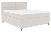 Boxspringbett in seitlicher Perspektive mit hellem Stoffbezug und schlichtem Design.