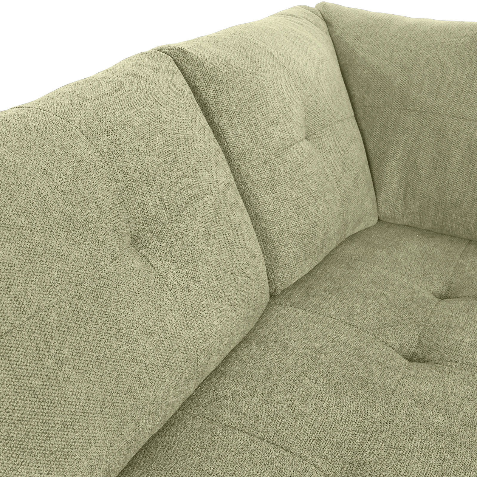 Nahaufnahme einer grünen Sofaecke mit gepolsterten Kissen und strukturierter Oberfläche, Perspektive von oben.