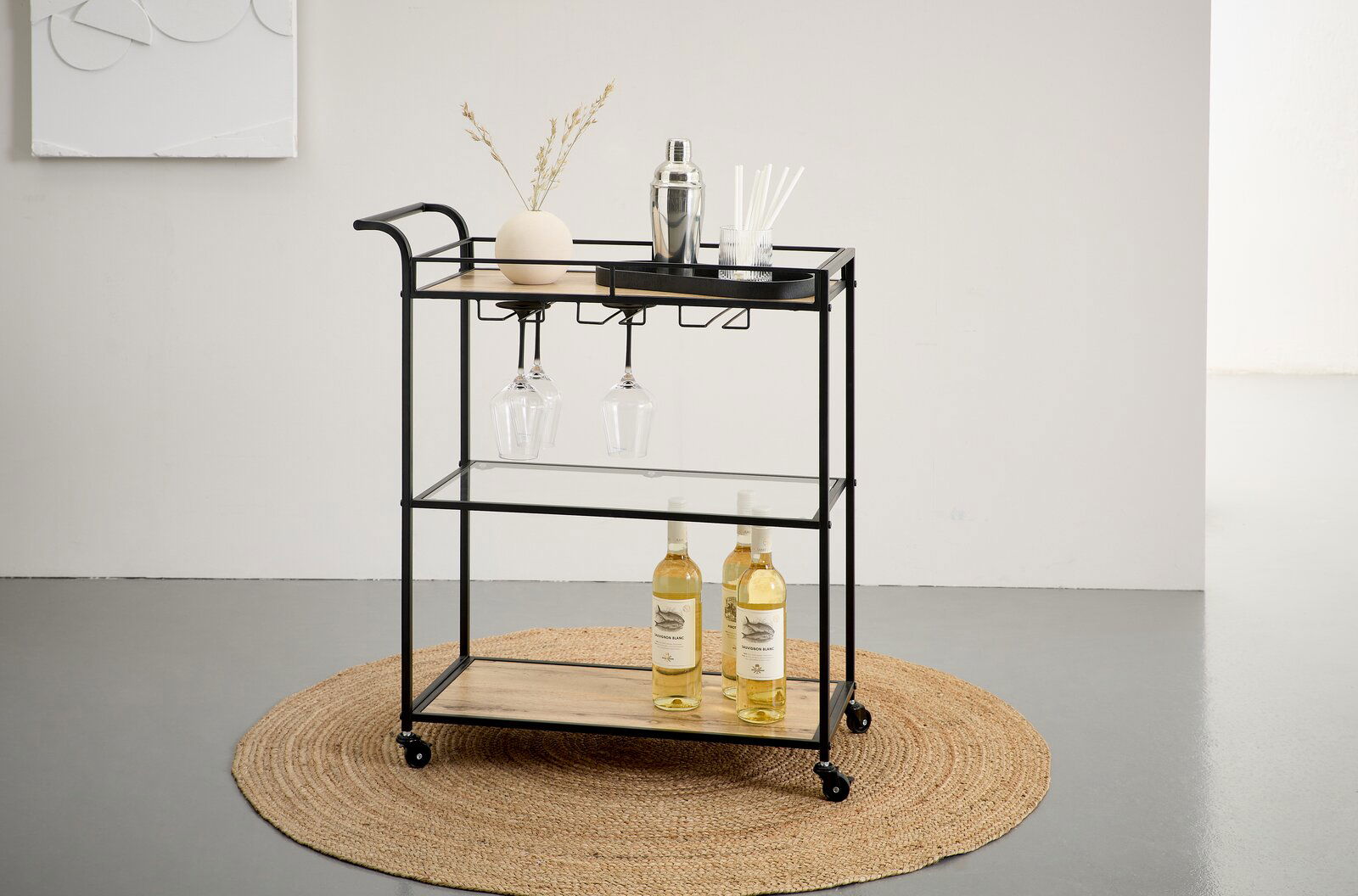 Schwarzer Barwagen/Servierwagen aus Metall mit Holzablagen und Glasboden, mit hängenden Weingläsern und Flaschen, auf Rollen – Frontansicht in leicht schräger Perspektive.