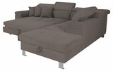 Ecksofa in Grau mit verstellbaren Kopfstützen und mehreren Kissen, Perspektive von vorne links