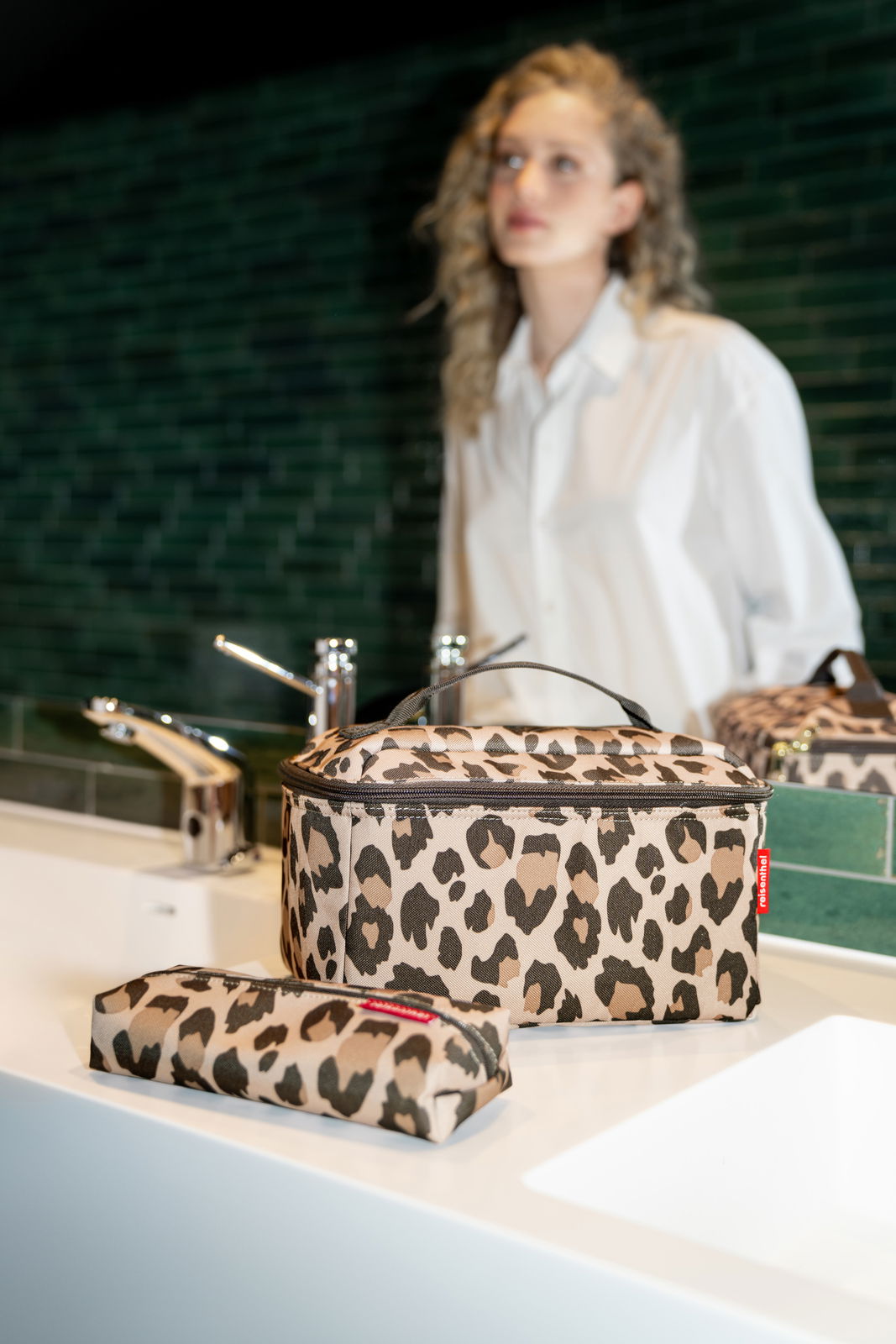 Beautycase-Set mit Leopardenmuster auf einem Waschbecken, seitliche Perspektive