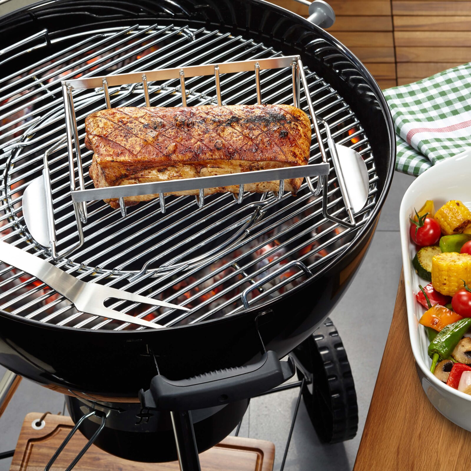 Spare Rib Halter auf einem Grill mit gegrillten Rippchen, seitliche Perspektive