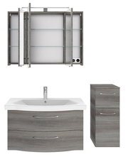 Badblock-Set mit grauem Holzfinish, bestehend aus einem Spiegelschrank mit Glasböden, einem Waschbeckenunterschrank mit zwei Schubladen und einem hohen Schrank mit zwei Schubladen, frontal abgebildet.