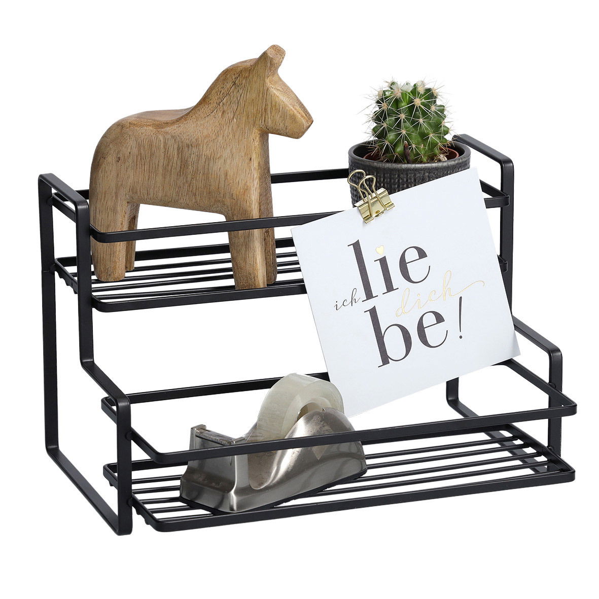 Schwarzes Metallregal mit zwei Ebenen, dekoriert mit einem hölzernen Pferd, einem Kaktus in einem Topf und einem Notizzettel mit der Aufschrift 'ich liebe dich'. Perspektive: Frontalansicht.