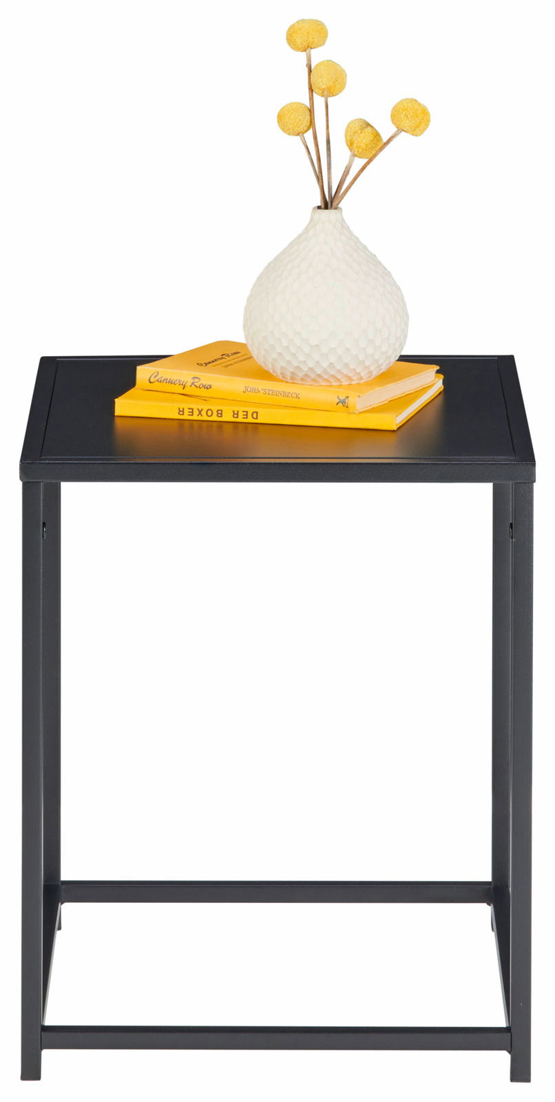 Schwarzer Beistelltisch mit gelben Büchern und weißer Vase, frontal betrachtet.