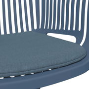 Nahaufnahme eines blauen Stapelsessels mit gepolstertem Sitzkissen, seitliche Perspektive