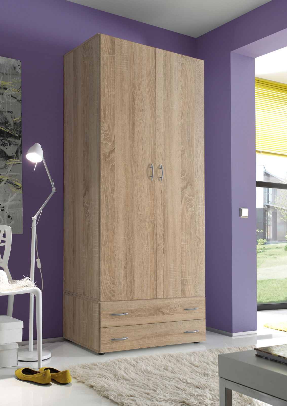 Zweiflügeliger Drehtürenschrank aus Holz in Eichenoptik, frontal fotografiert, mit zwei Schubladen unten, in einem modern eingerichteten Raum mit lila Wand.