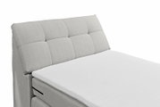 Boxspringbett mit grauem, gestepptem Kopfteil, seitliche Perspektive
