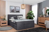 Modernes Boxspringbett in einem stilvoll eingerichteten Schlafzimmer, seitliche Perspektive.