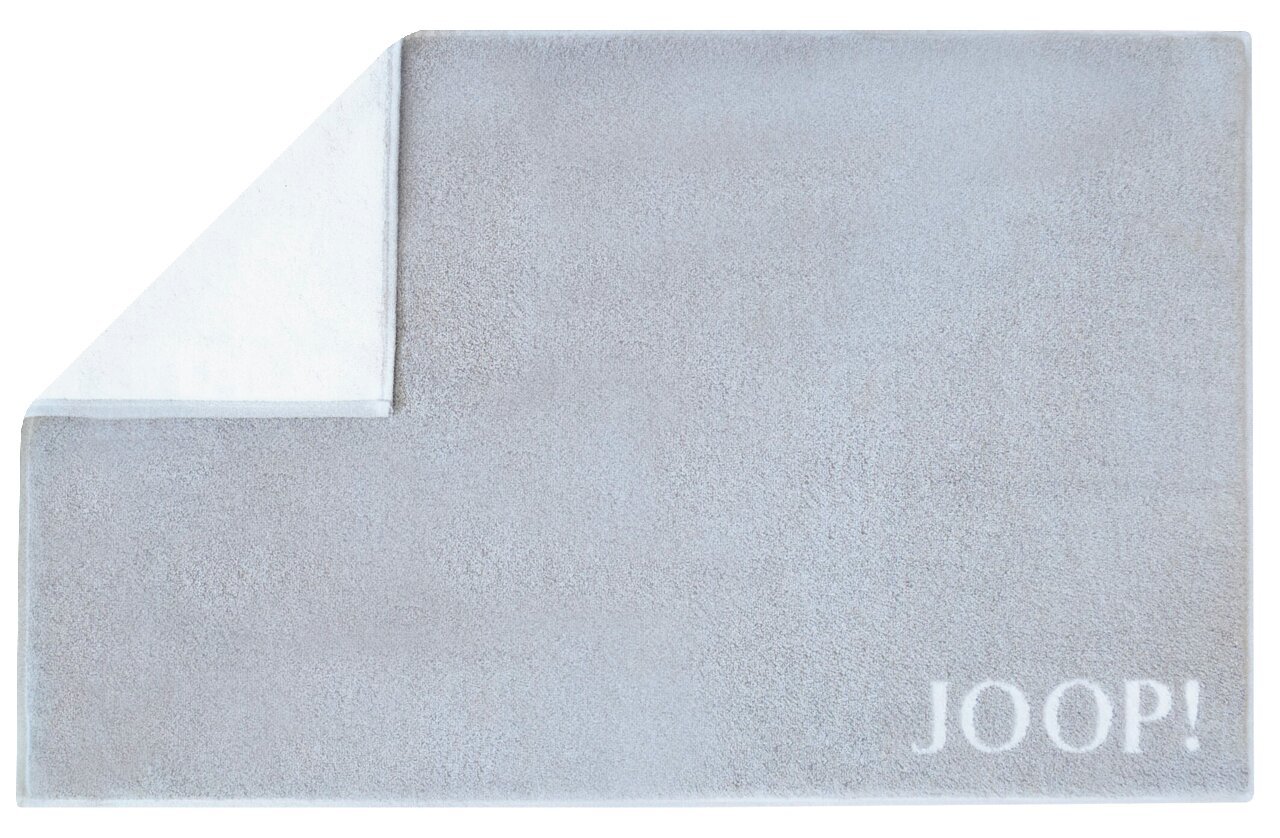 JOOP! Badematte DOUBLEFACE Graue Badematte mit umgeschlagener Ecke und dem Schriftzug 'JOOP!' in der unteren rechten Ecke, Draufsicht.