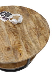 Runder Couchtisch aus Holz mit natürlicher Maserung, von oben fotografiert, mit weißen Kopfhörern und Fotos darauf.