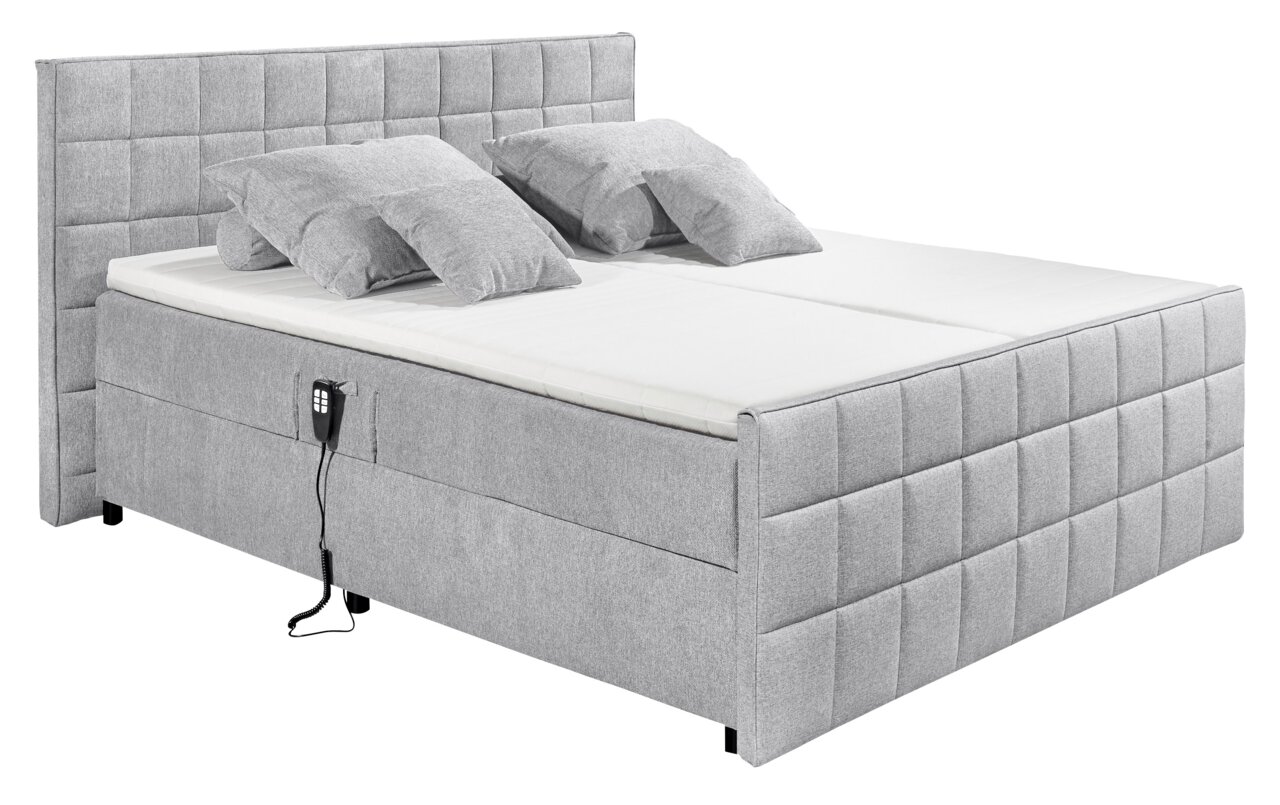 Graues Polsterbett mit hohem Kopfteil und zwei Kissen, seitliche Perspektive