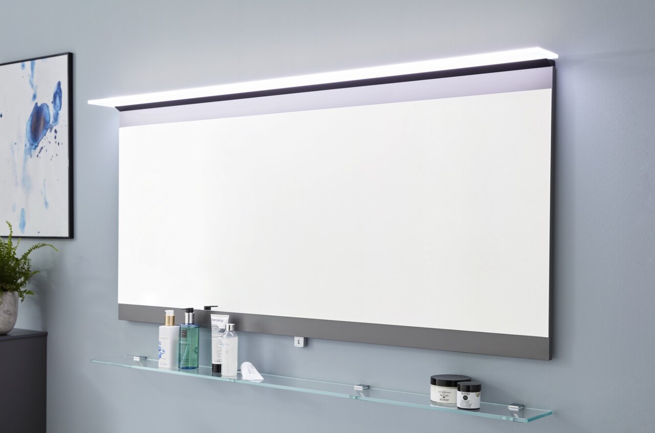 Moderne Badkombination mit großem rechteckigem Spiegel und integrierter LED-Beleuchtung, seitliche Perspektive