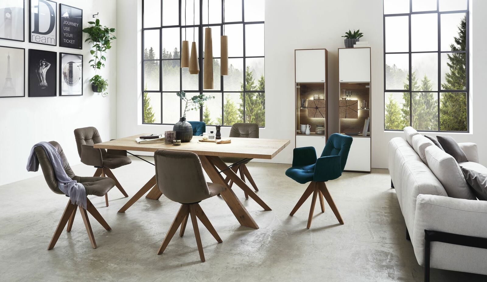 Moderne Vitrine in einem stilvollen Wohnzimmer, rechts im Bild, mit Glasfront und Holzdetails, umgeben von eleganten Möbeln und großen Fenstern.