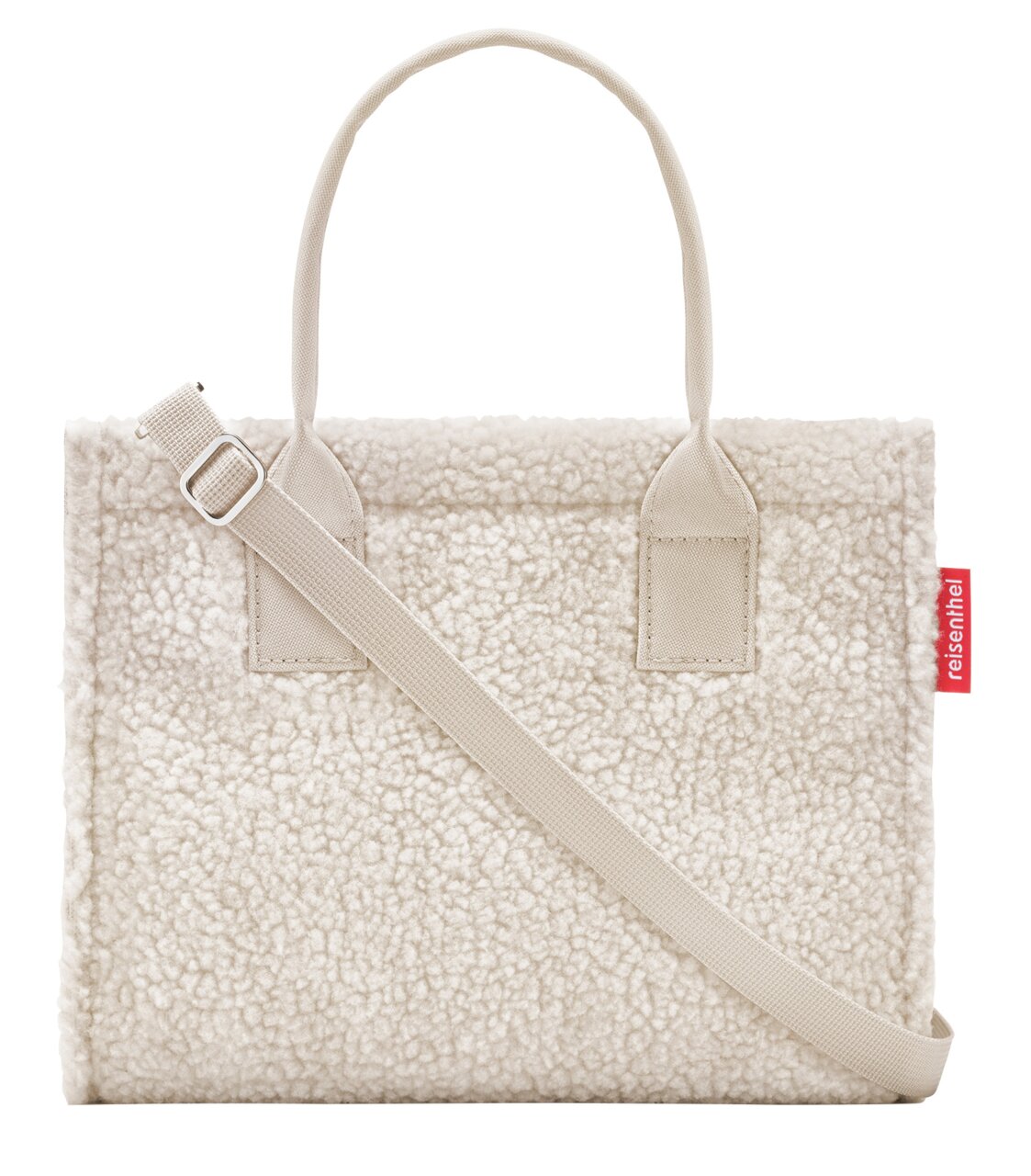 Vooraanzicht van een kleine, crèmekleurige shopper met een zacht, donzig oppervlak en een verstelbare schouderriem.