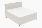 Boxspringbett in seitlicher Perspektive mit hellem Stoffbezug und schlichtem Design