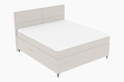 Boxspringbett in seitlicher Perspektive mit hellem Stoffbezug und schlichtem Design