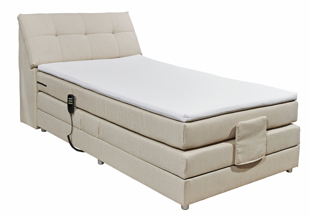 Beiges Boxspringbett mit verstellbarem Kopfteil und Fernbedienung, seitliche Perspektive